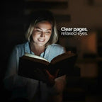 VisionGlow book light — clear pages relaxed eyes — smiling young woman reading with bright even light on book in dark background