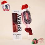 Tazzi MistPro Spray Comb in pink colorway styled as a Christmas gift — product wearing a Santa hat and red scarf with 'Merry Christmas Gift' text and festive decorations in the background