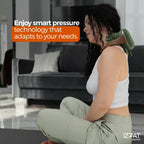 Woman sitting upright with the Tazzi RelaxingTouch massager around her neck, demonstrating smart pressure adjustment — office or home-use context showing ergonomic comfort